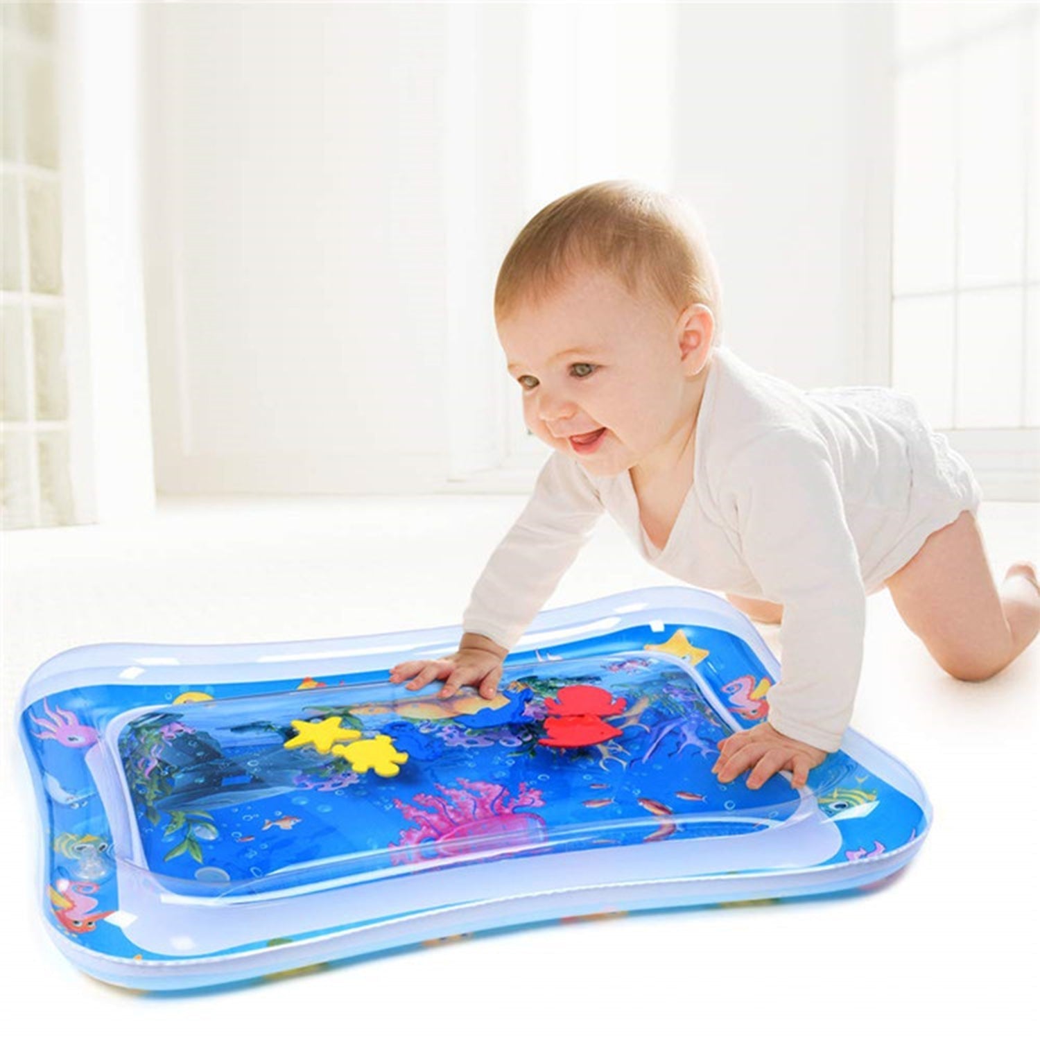 A baby observing the dynamic movement of toys within the transparent Baby Water Mat.