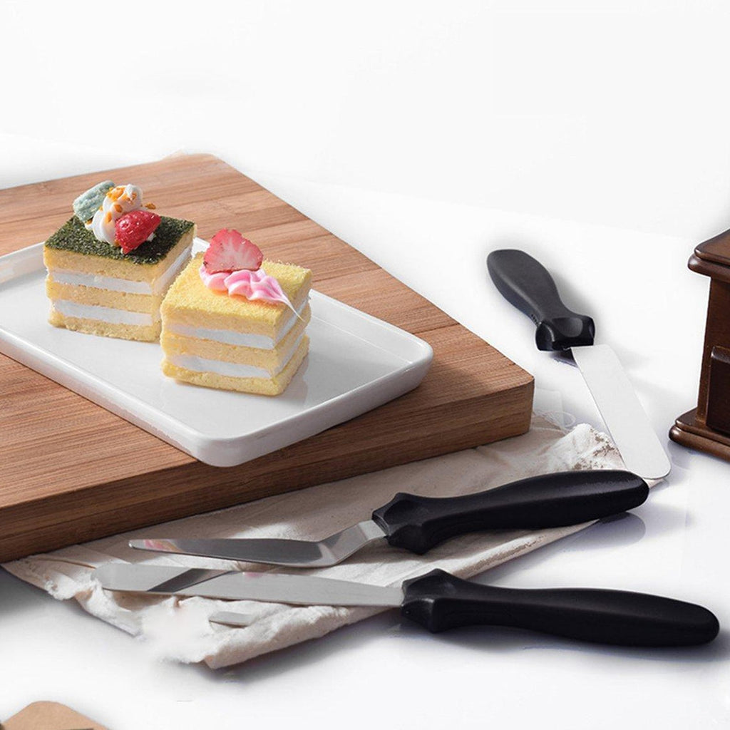A complete set of stainless steel cake icing spatulas, featuring flat, angular, and triangle pallet knives.