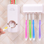 Clean bathroom countertop showcasing the space-saving automatic toothpaste dispenser and toothbrush holder.
