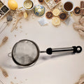 Durable stainless steel strainer filtering soup, juice, and tea in a kitchen.