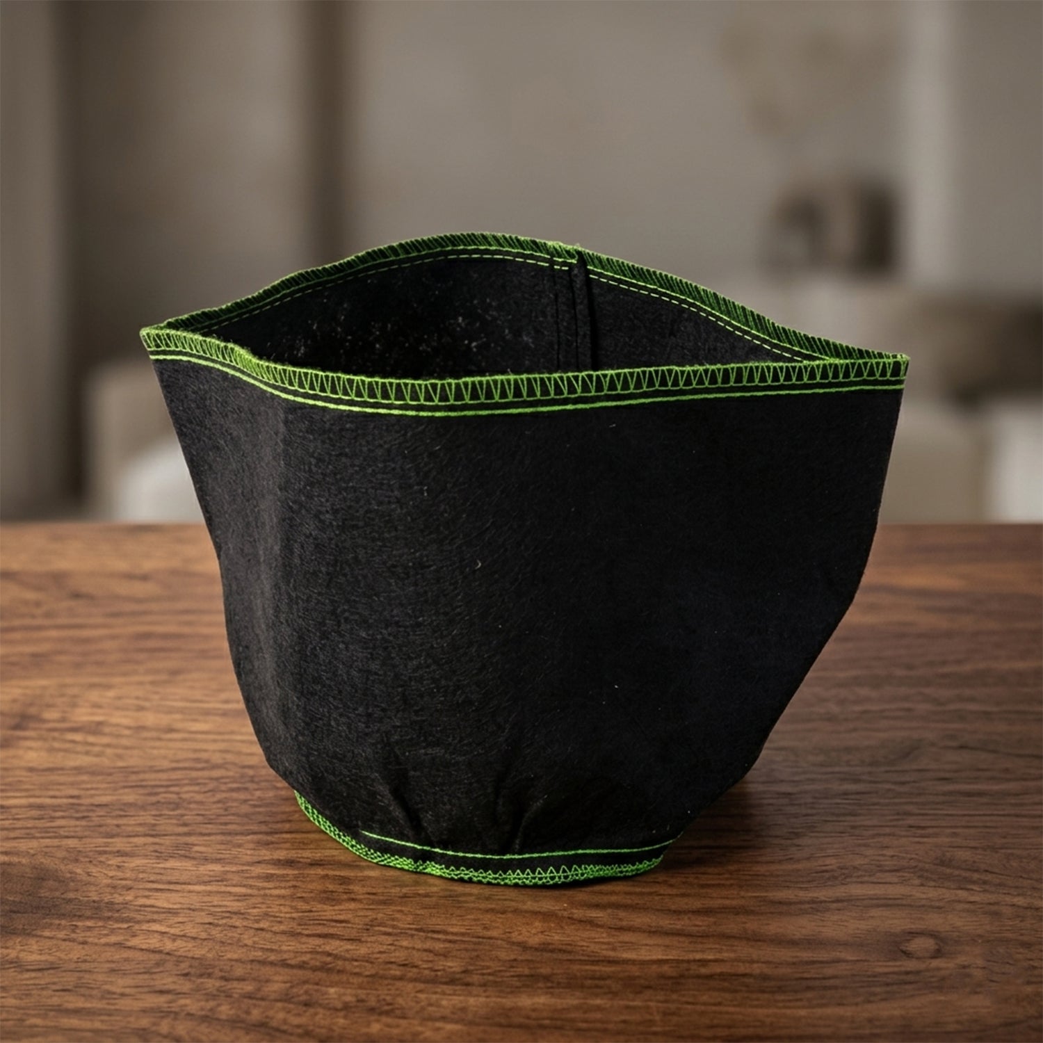 Green stitched fabric storage basket in a compact, foldable design