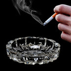 Elegant round crystal glass ashtray with a smooth finish, perfect for indoor or outdoor use.
