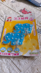 Product packaging showing a set of two strong self-adhesive hooks by Indo Glow.