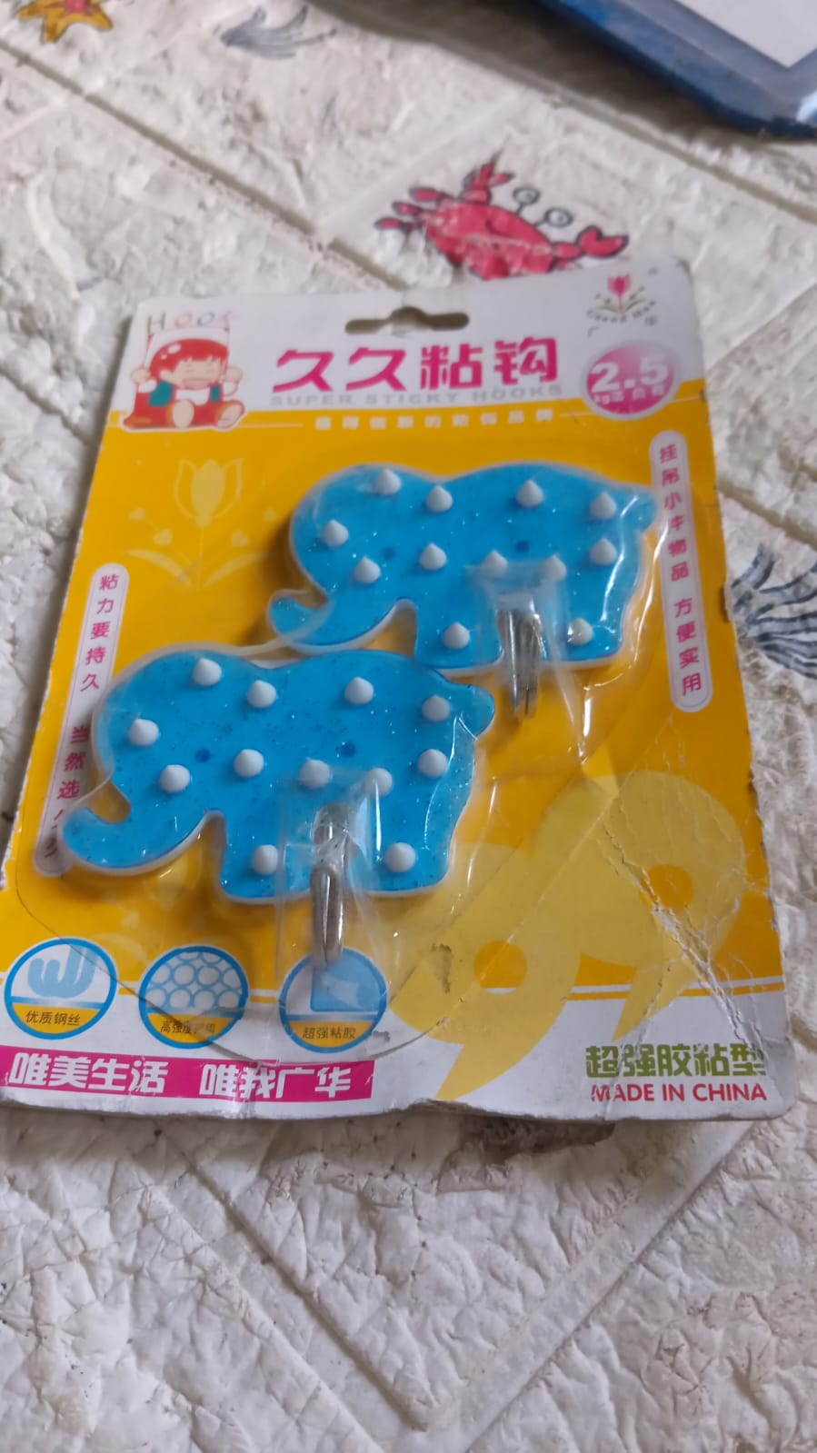 Product packaging showing a set of two strong self-adhesive hooks by Indo Glow.