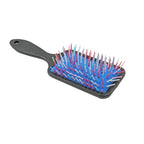 Hand using the Scalp Massager Comb on a scalp, demonstrating gentle massage action.