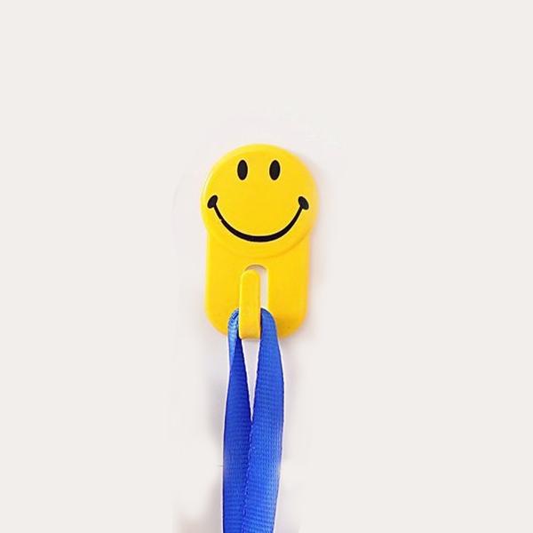 Packaging shot of the six-piece set of self-adhesive smiley face hooks.