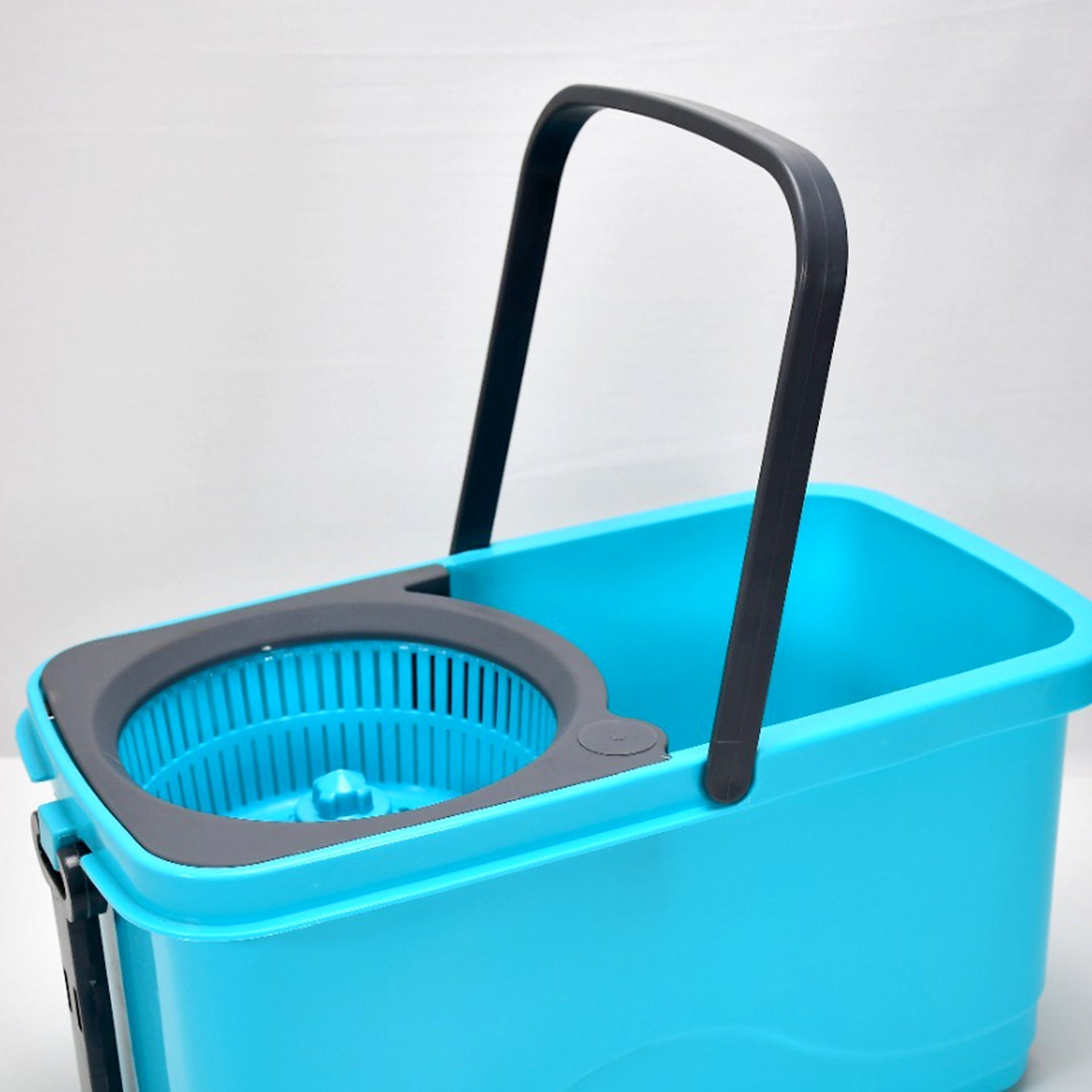 Large capacity spin mop bucket with hands-free wringer mechanism.