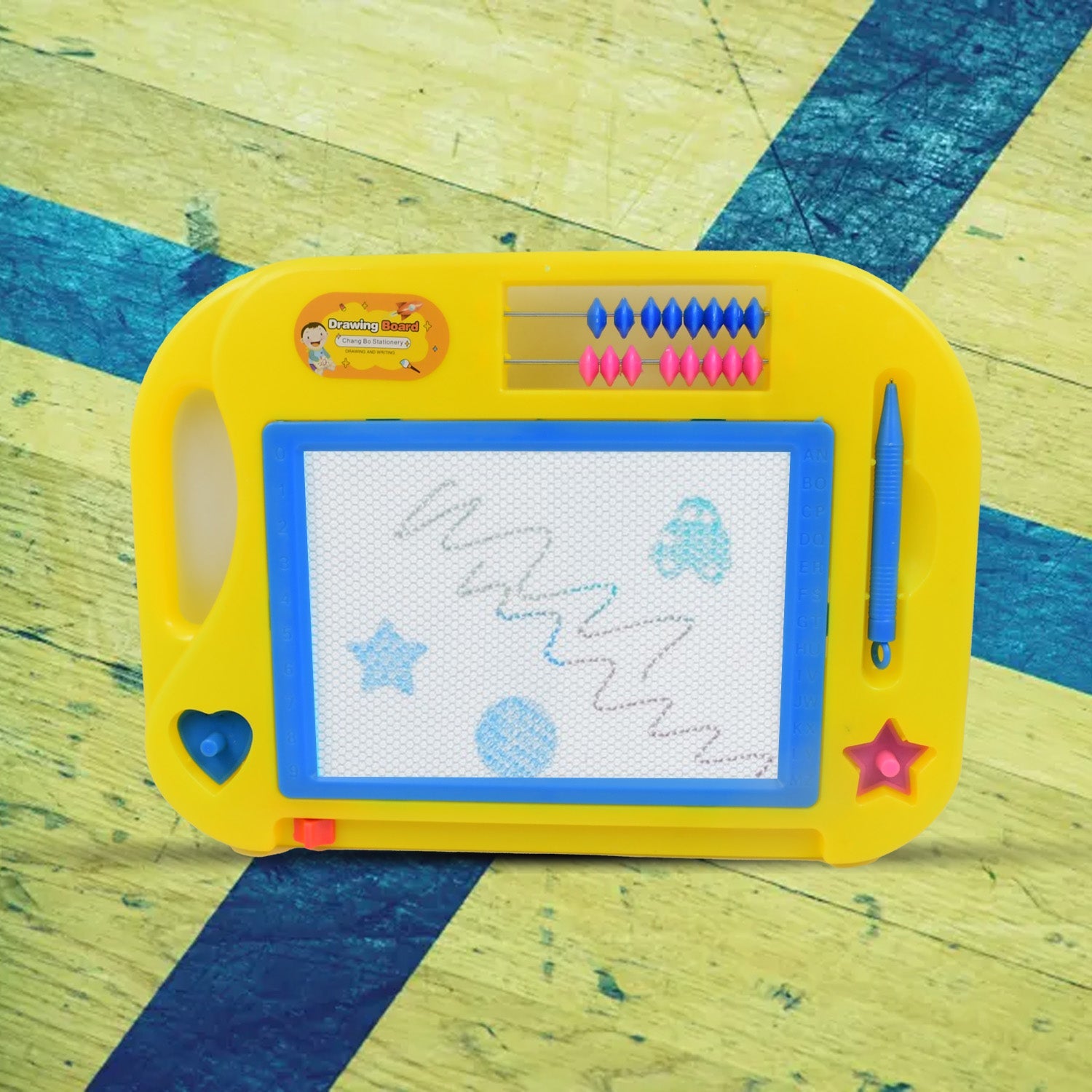 Close-up of a child drawing on the Magic Sketch Slate with the attached stylus pen.