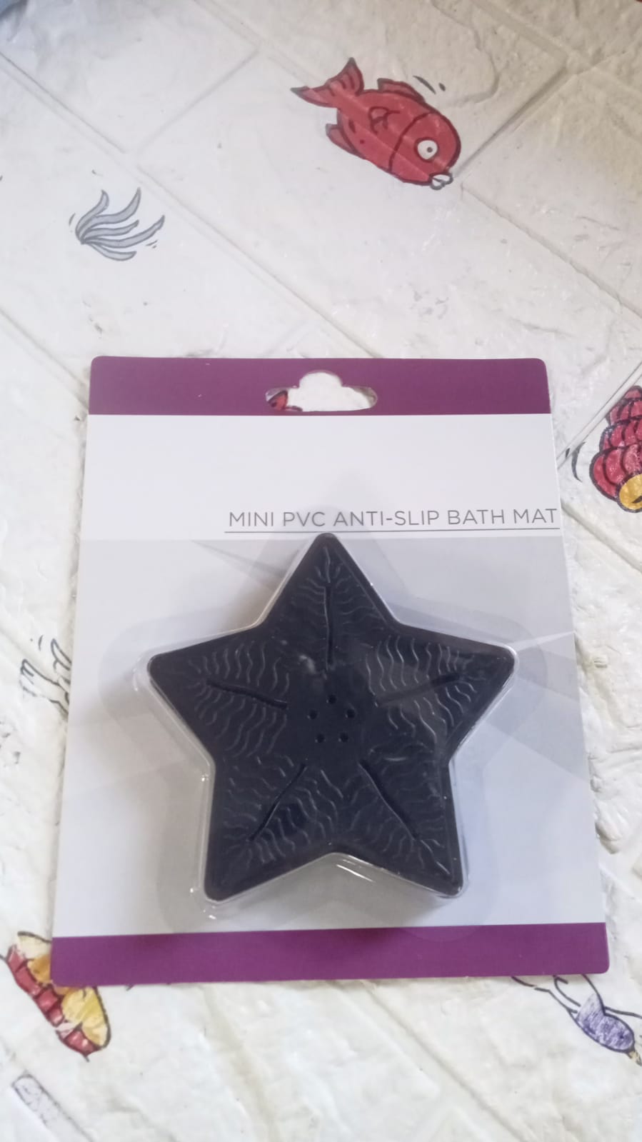 Four colourful star-shaped bath mats in their packaging, ready for use.
