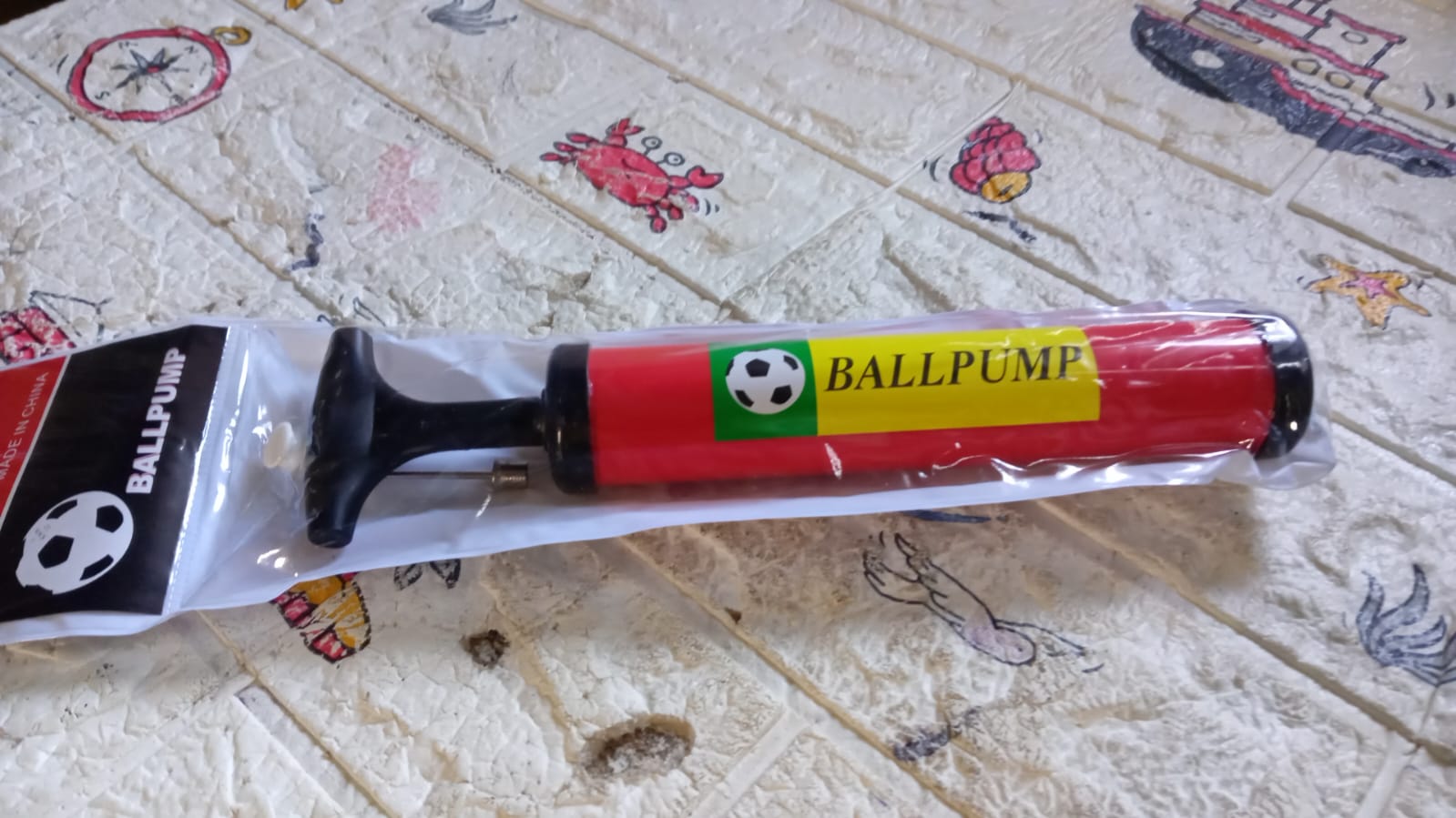The 24CM sports ball pump and accessories displayed on a clean surface.