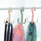 A brown handbag neatly hung on the 360-degree rotatable purse hanger hook, demonstrating its utility.