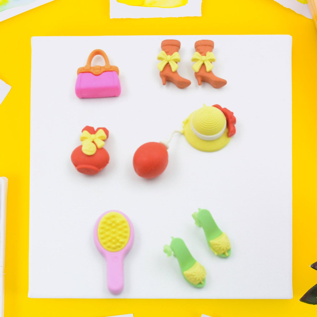 Top-down view of the 9-piece set of fun mini erasers, showcasing variety.