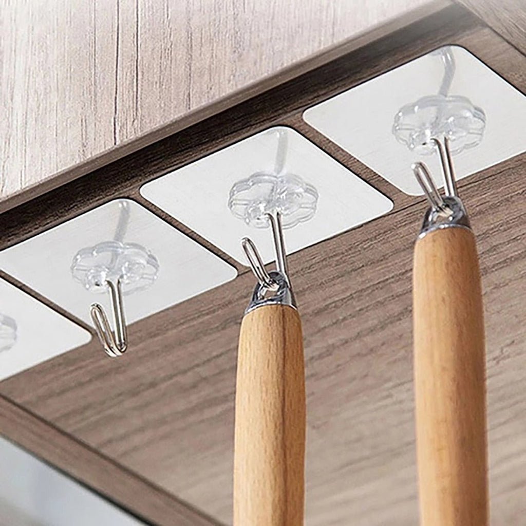 Multiple stainless steel adhesive wall hooks organized on a surface, highlighting their sleek appearance.