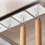 Multiple stainless steel adhesive wall hooks organized on a surface, highlighting their sleek appearance.