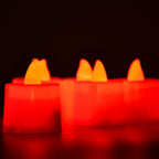 Red LED flameless tealight candle showing its on/off switch and battery compartment