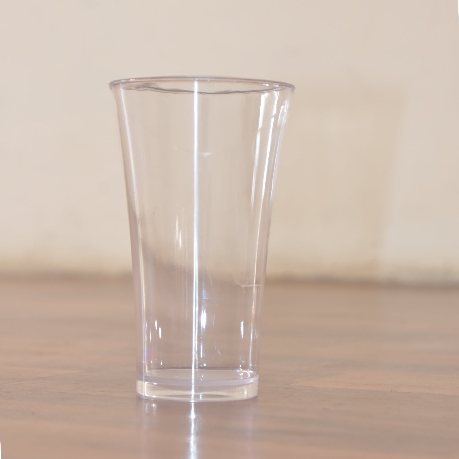 Stack of transparent plastic water glasses for compact storage.