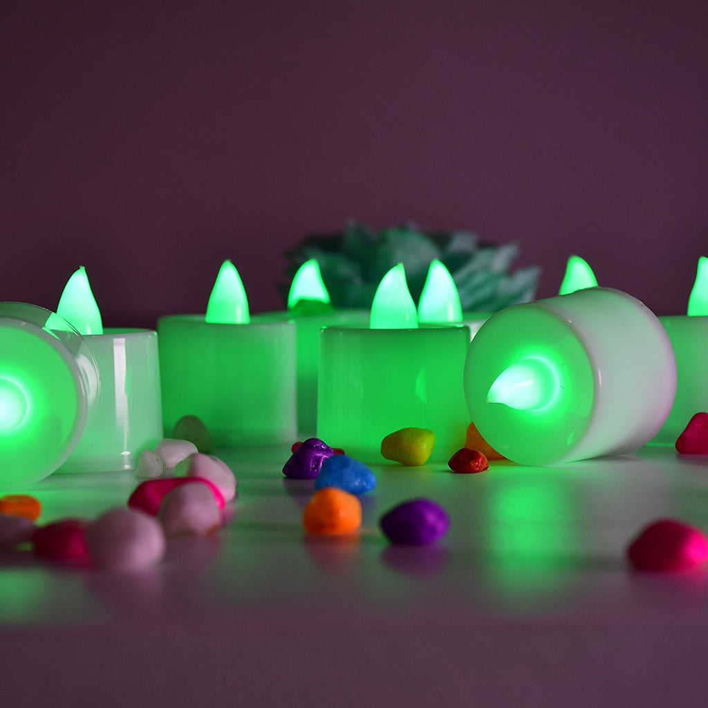 Several green LED flameless candles illuminating a space.