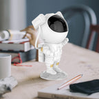 Close-up of the astronaut star projector creating a vibrant starry sky effect.