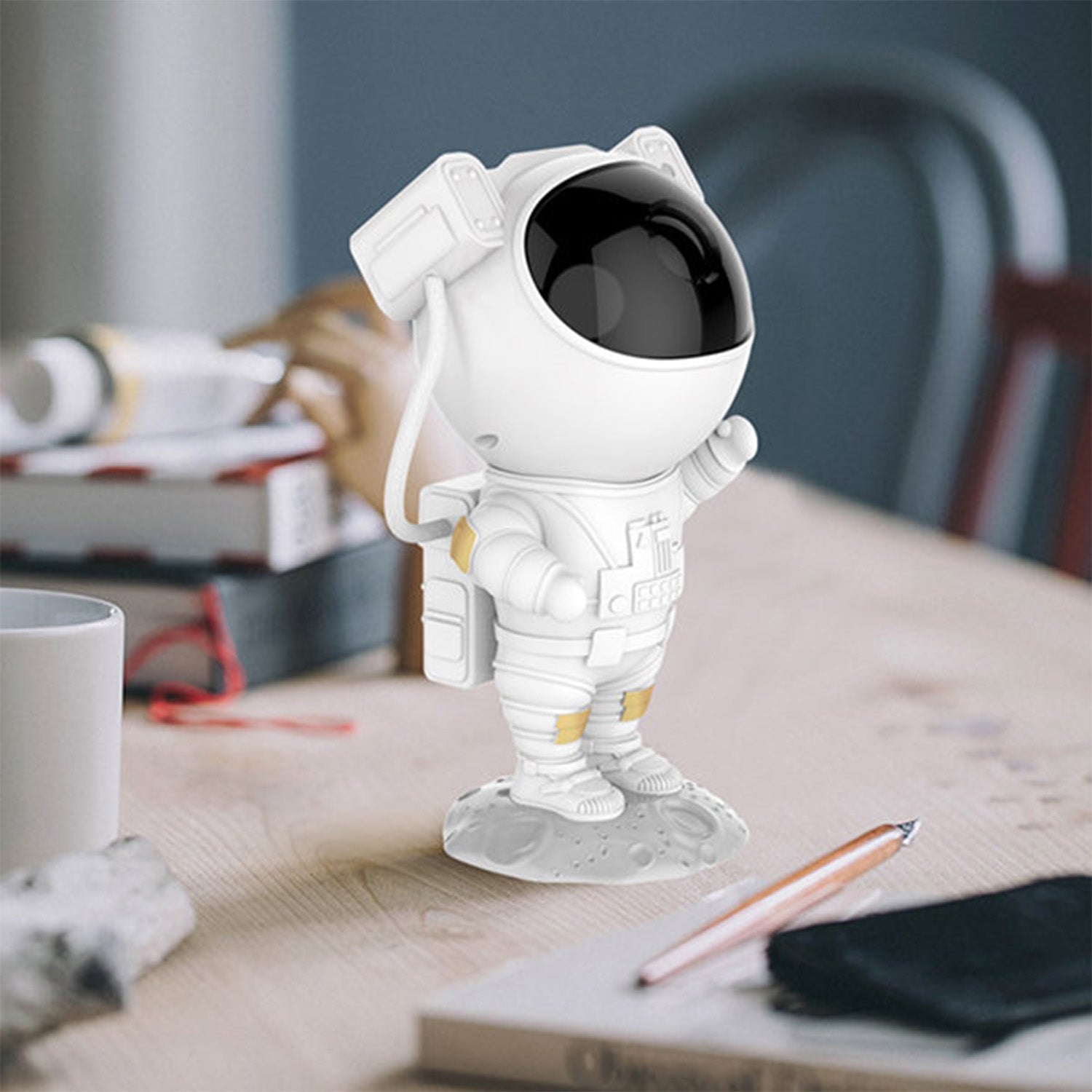 Close-up of the astronaut star projector creating a vibrant starry sky effect.