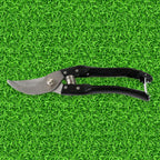 Garden shears making a clean cut on small branches, promoting plant health.