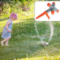 A 360° rotating garden sprinkler with four adjustable arms, watering a lush green lawn.