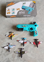 Kids enjoying the outdoor airplane gun toy, launching planes in a park.
