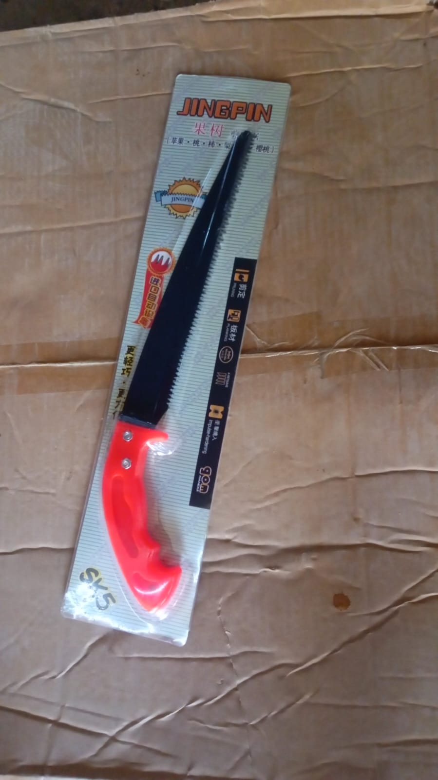 Another view of the hand pruning saw with its protective cover.