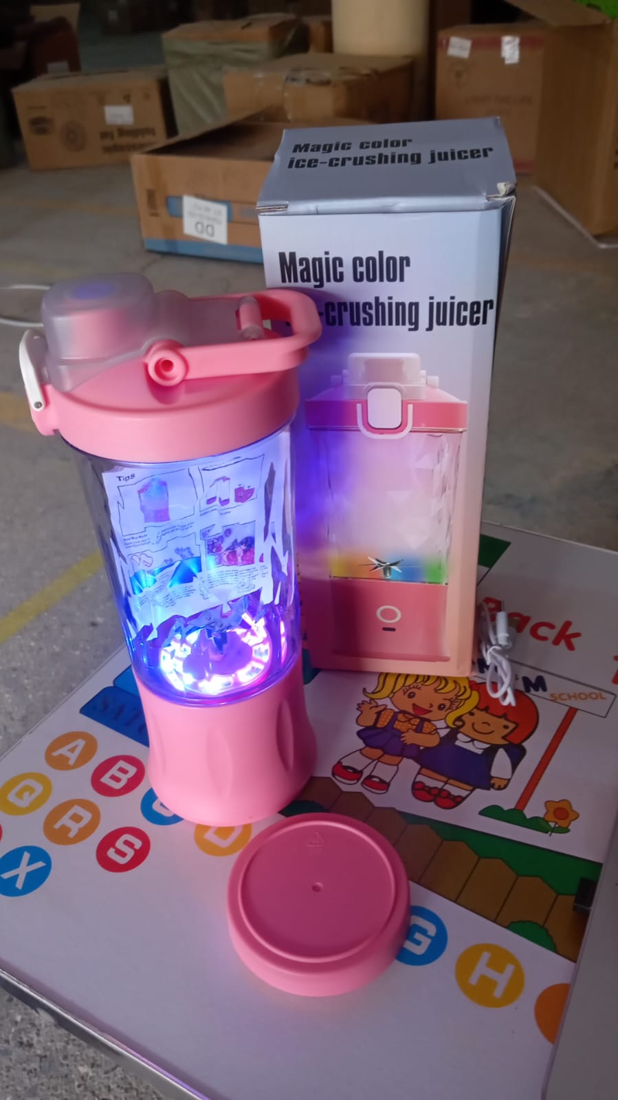 The electric portable juicer glowing with dynamic multicolor lighting effects.