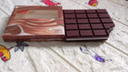 A child's hands writing in the fun chocolate scented bite-shape diary.