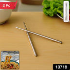Close-up of sleek stainless steel chopsticks resting on a dining table.