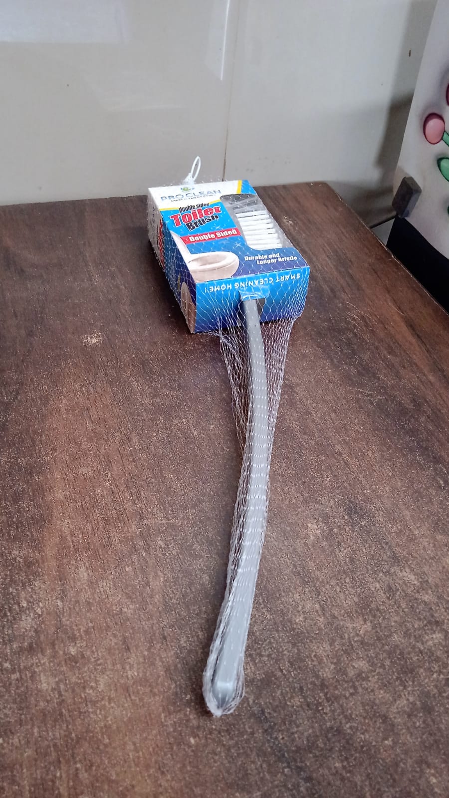 Pro Clean long handle toilet brush stored neatly in bathroom