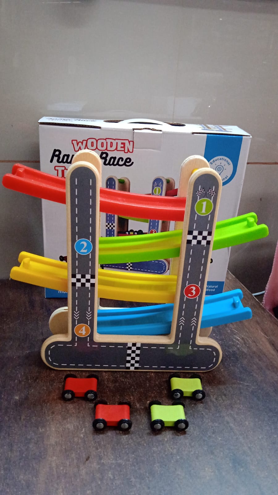 Packaging box for the wooden race track toy, showing its contents.
