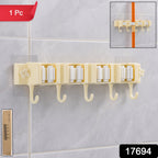 Wall-mounted broom holder securely gripping handles in household utility room