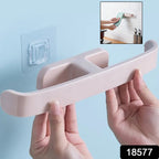 Self-Adhesive Towel Rack mounted on a modern bathroom wall, holding towels and slippers.