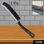 Ergonomic handheld Crevice Cleaning Brush tackling kitchen tile gaps.