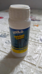 Drain cleaning powder effectively removing blockages from a kitchen sink.