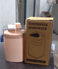 Automatic toothpick dispenser in a minimalist setting, ready for use.