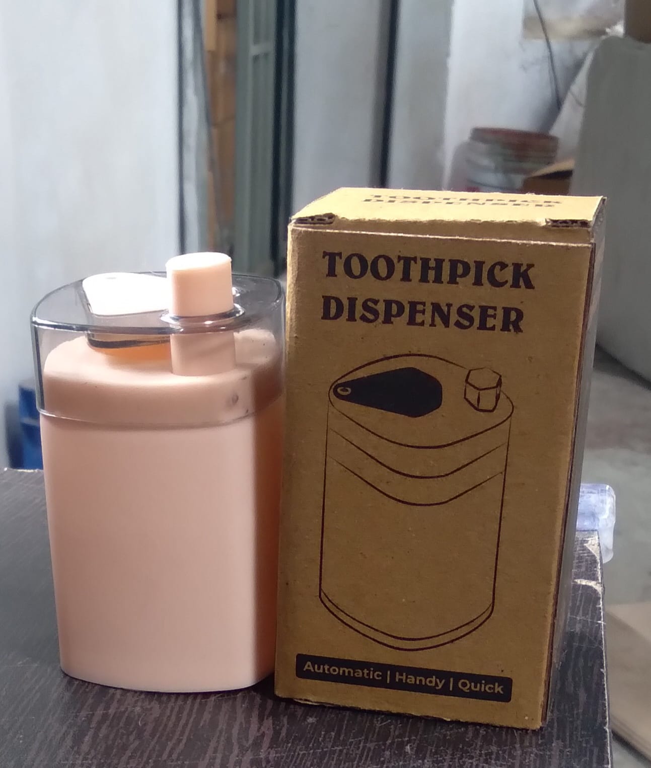 Automatic toothpick dispenser in a minimalist setting, ready for use.