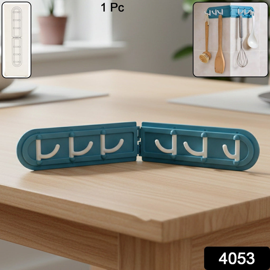 Foldable hook rack installed on kitchen wall holding utensils