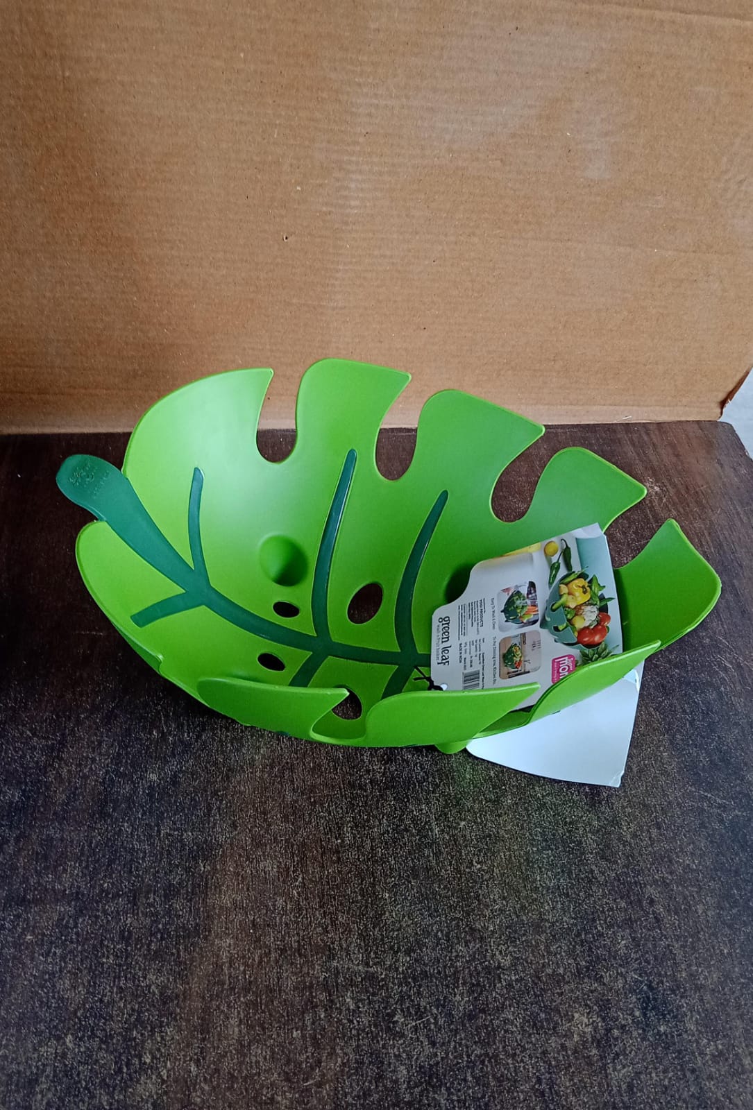 Decorative leaf-shaped fruit basket placed on kitchen countertop
