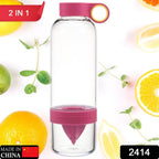 Side angle of the juice infuser bottle, showing a lemon half securely placed in the built-in juicer.