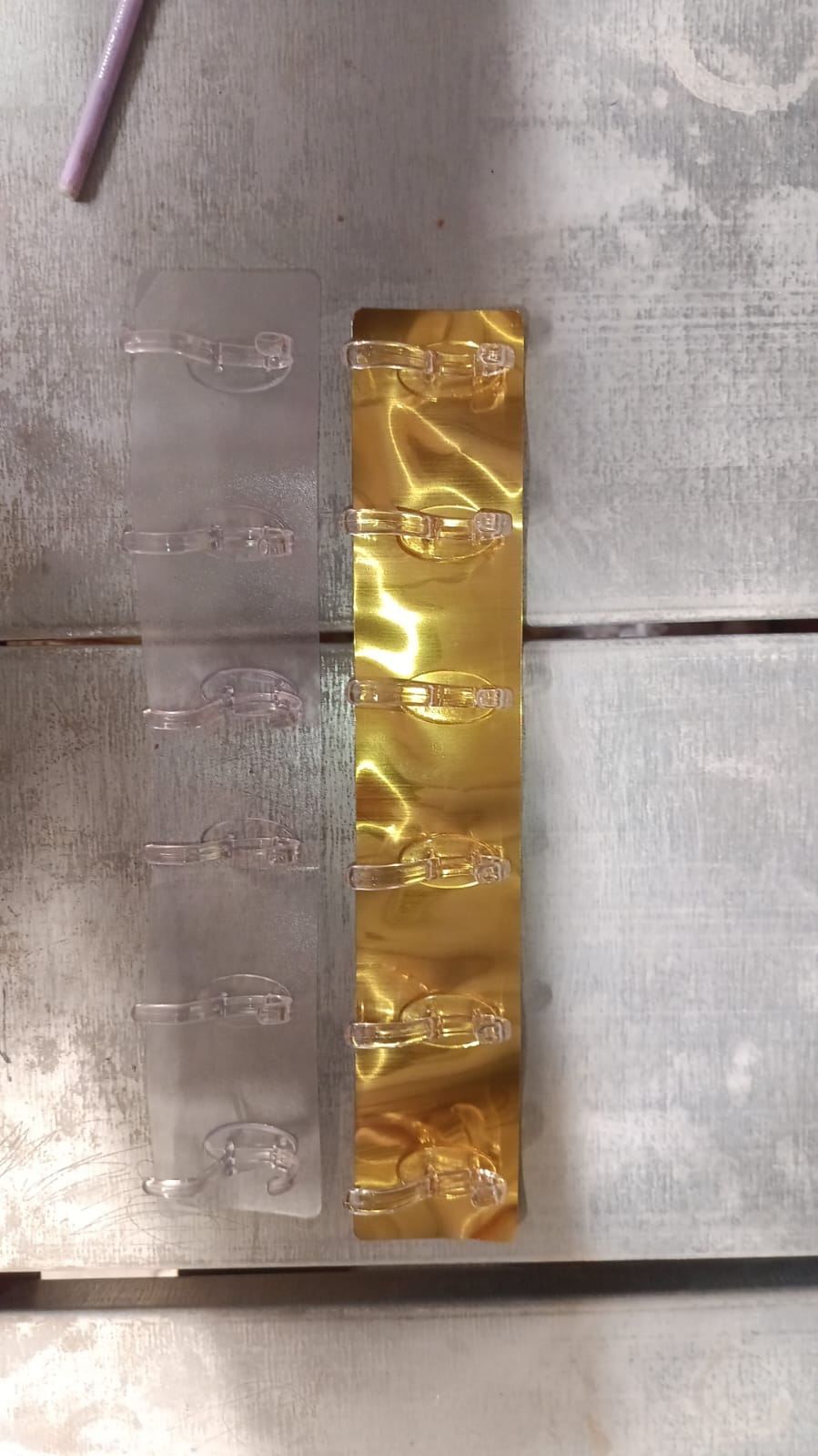 Front view of the heavy duty 6-pin wall hook rail with transparent and golden hooks.
