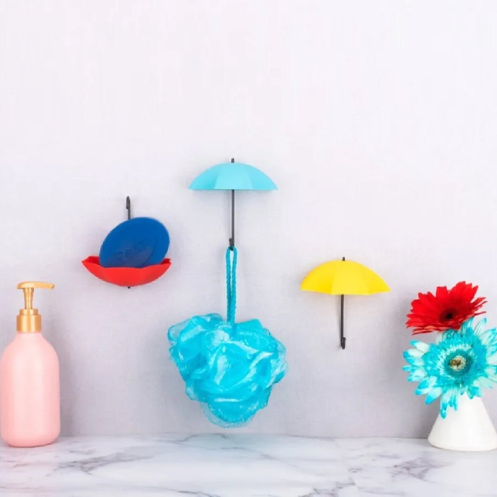 Close-up view of a vibrant umbrella wall hook, highlighting its small storage tray.