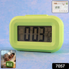 LCD desk alarm clock placed on office table displaying time and temperature