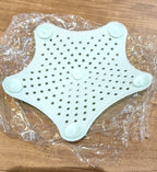 Star shaped silicone sink strainer protecting kitchen sink from hair and debris