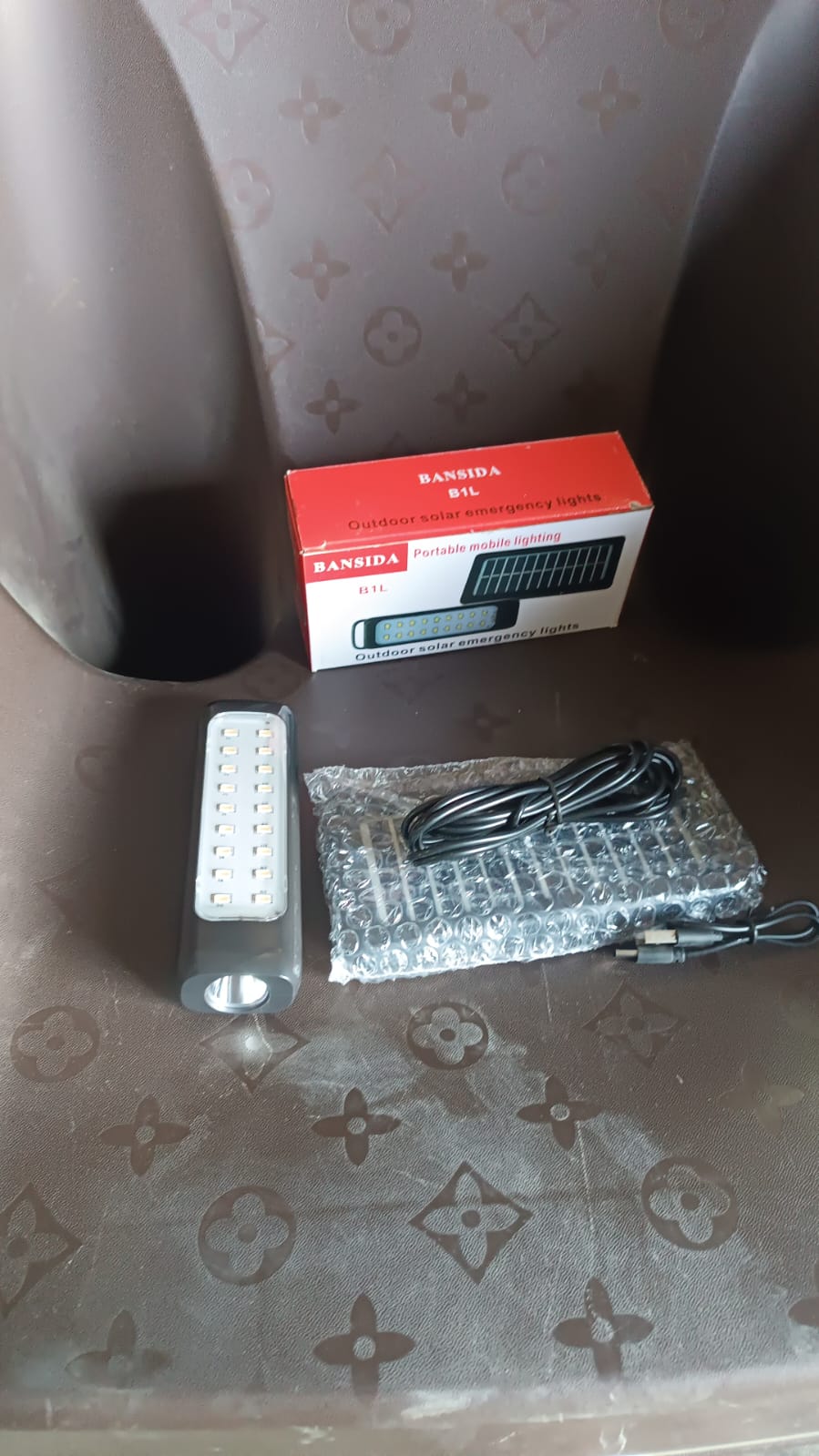 Outdoor solar light installed and glowing in garden setting at night