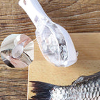 Hand demonstrating the safe use of the fish scale peeler tool on a fish.