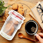 Group of three 500ml reusable plastic food storage pouches with zipper seals.