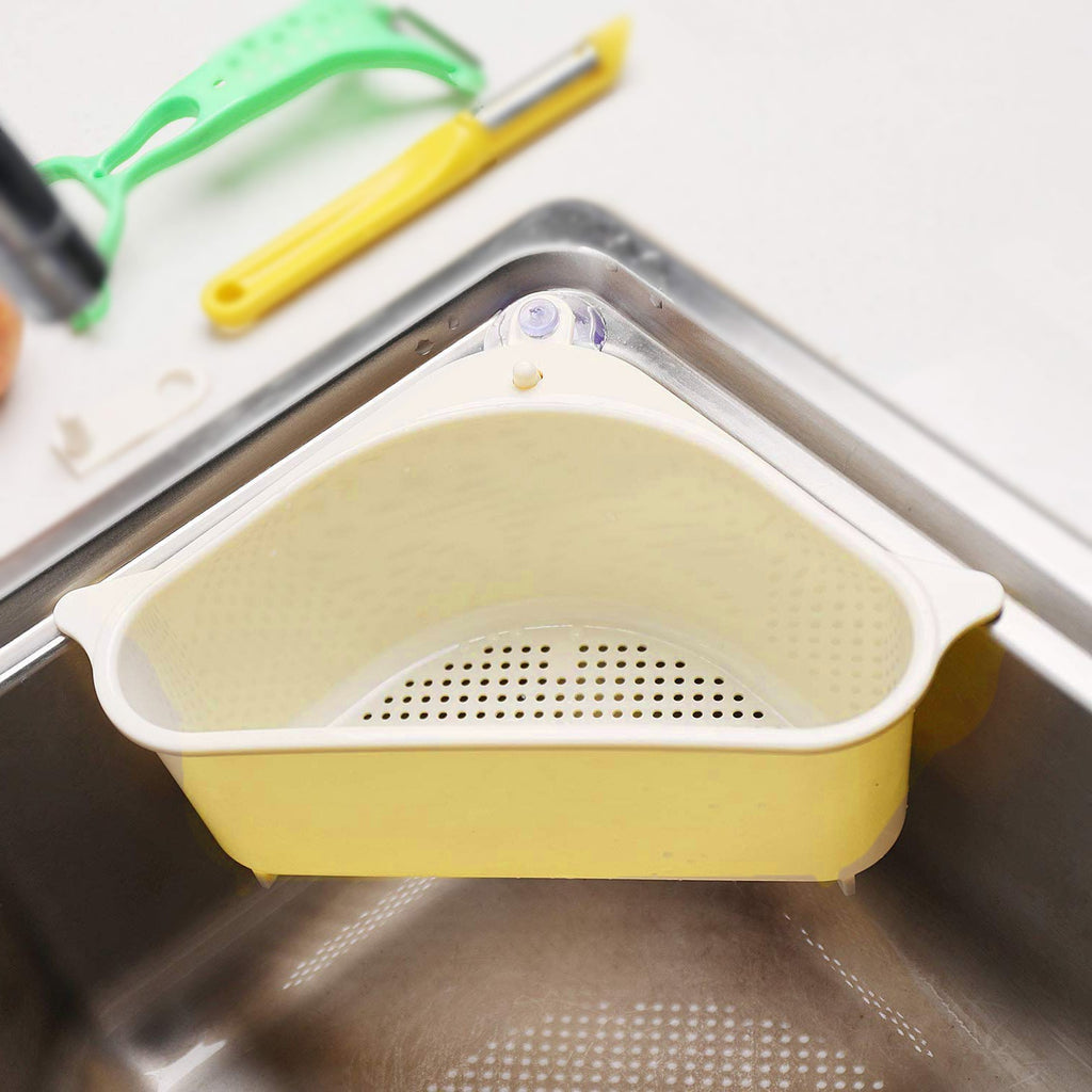 Corner sink drainer shelf holding a sponge and brush by a kitchen tap.