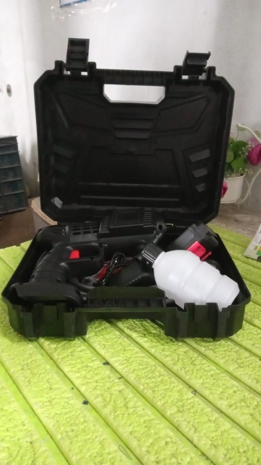 Lifestyle shot of the portable car washer gun being used for outdoor cleaning.